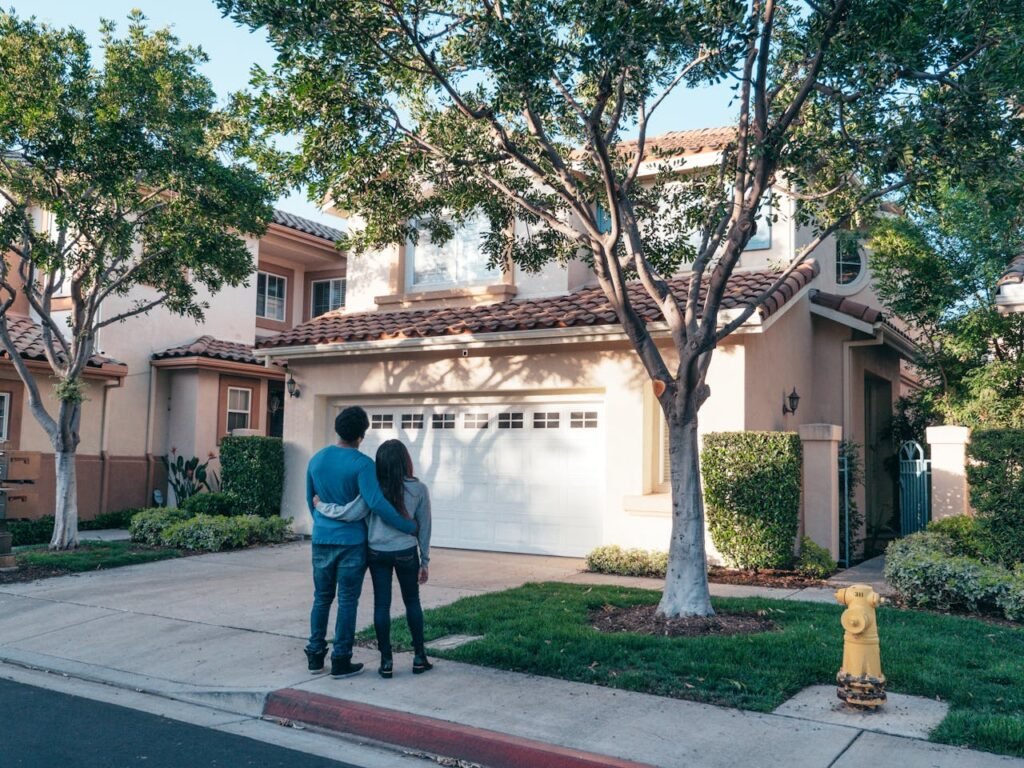 pexels-photo-7579042 Couple hugging outside their newly purchased suburban home, showcasing togetherness and new beginnings.